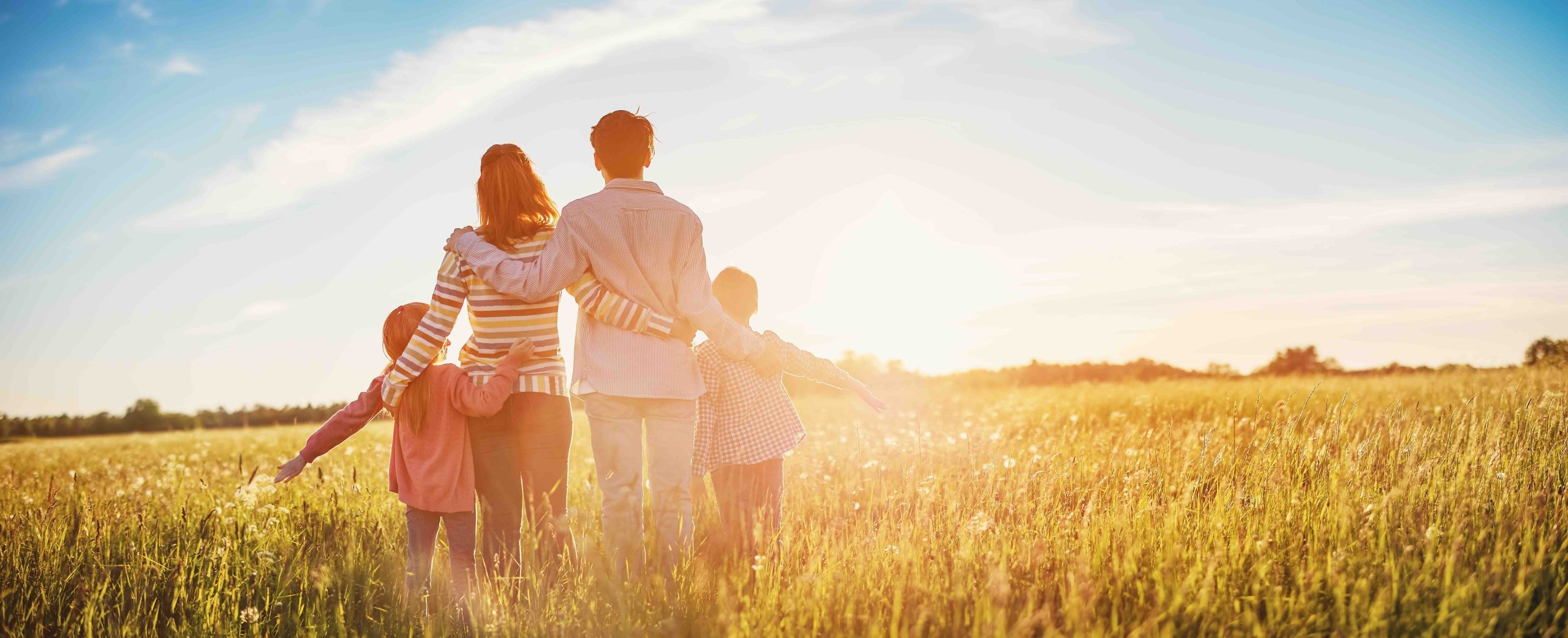 A happy family walking in the countryside having bought a home through Rowallan Buying Agents - A Buying Agent Simplifies £1m+ Moves